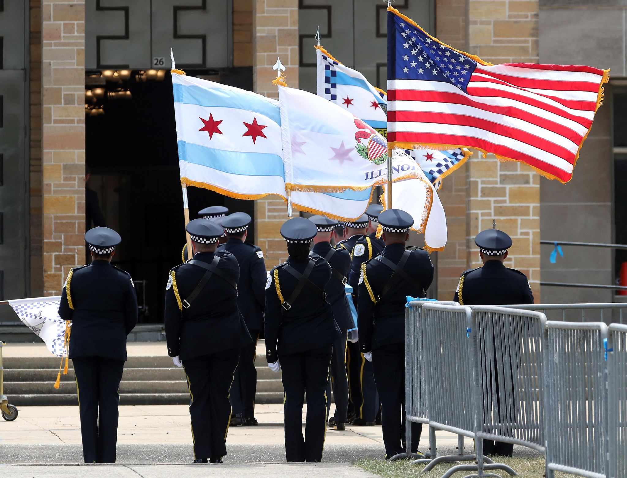 A Chicago police honor guard watches as the flag-draped casket...