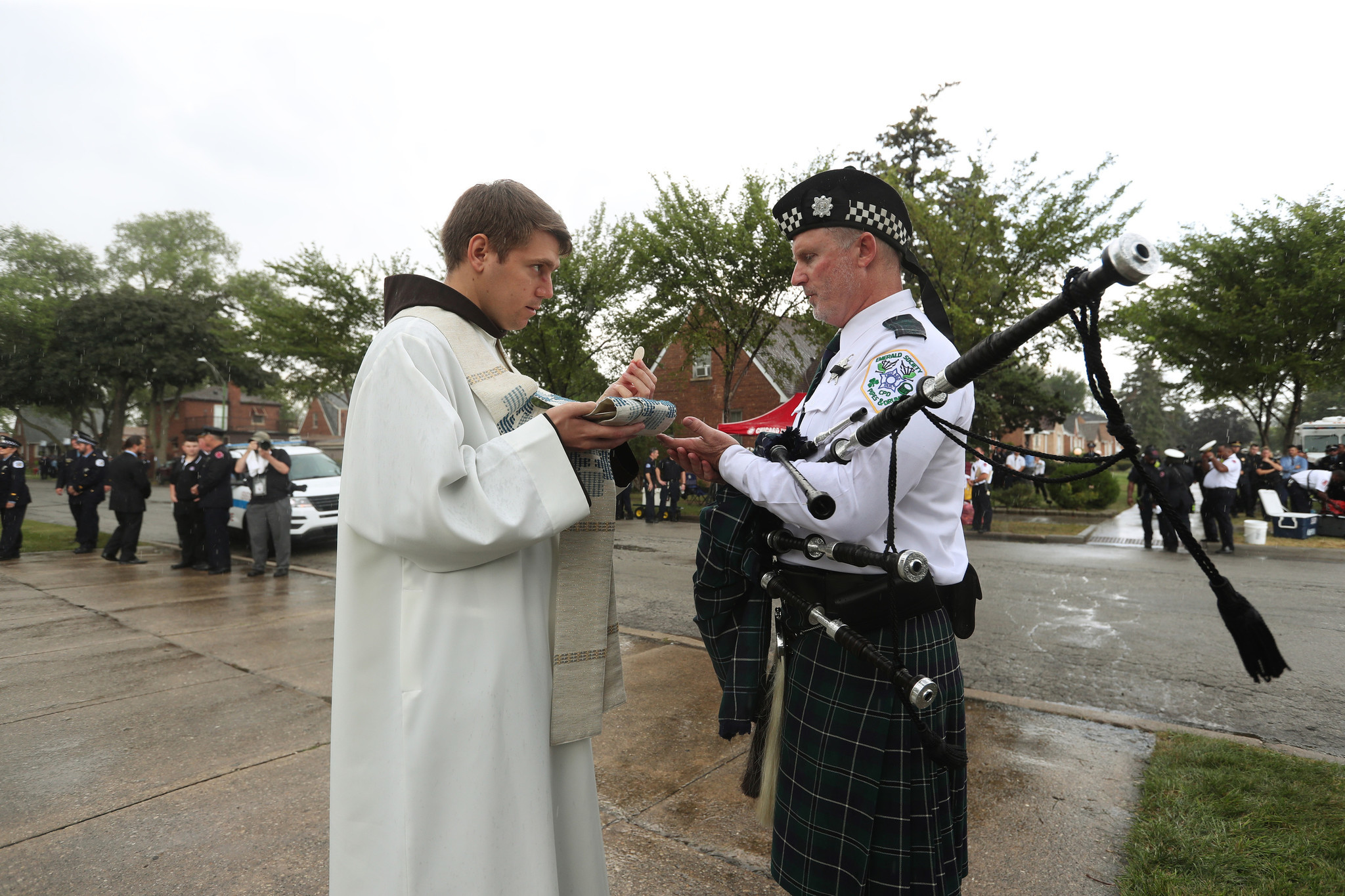 A bagpiper receives Holy Communion during the funeral for Chicago...