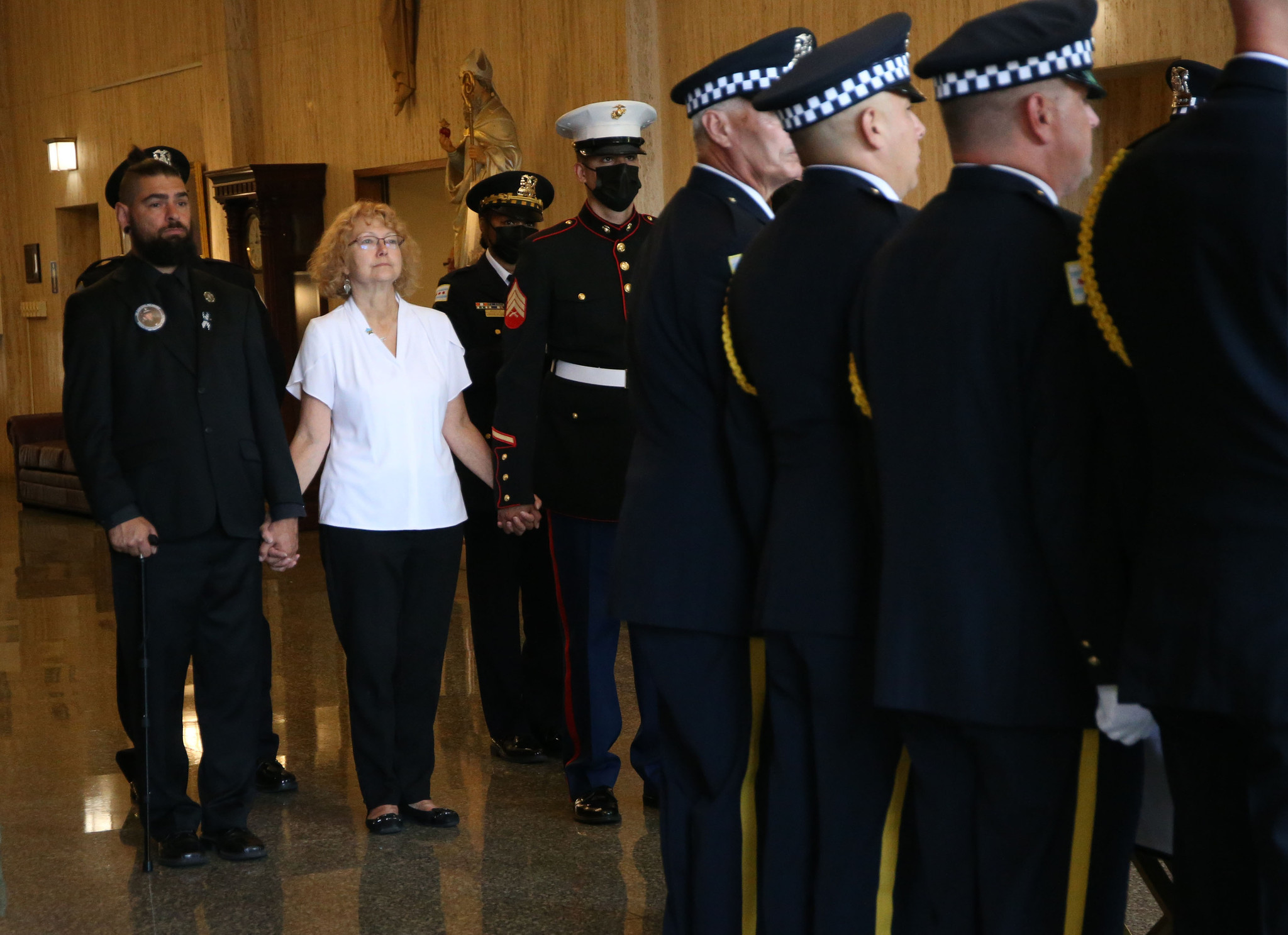 Elizabeth French looks on as the casket is prepared to...