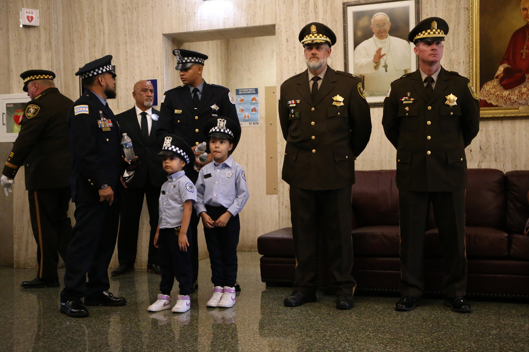 Chicago police officers and children wait in the vestibule before...