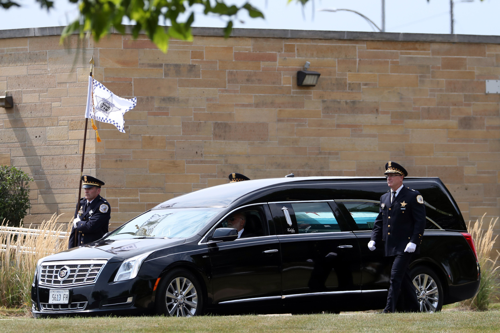 A hearse carrying the flag-draped casket bearing the remains of...