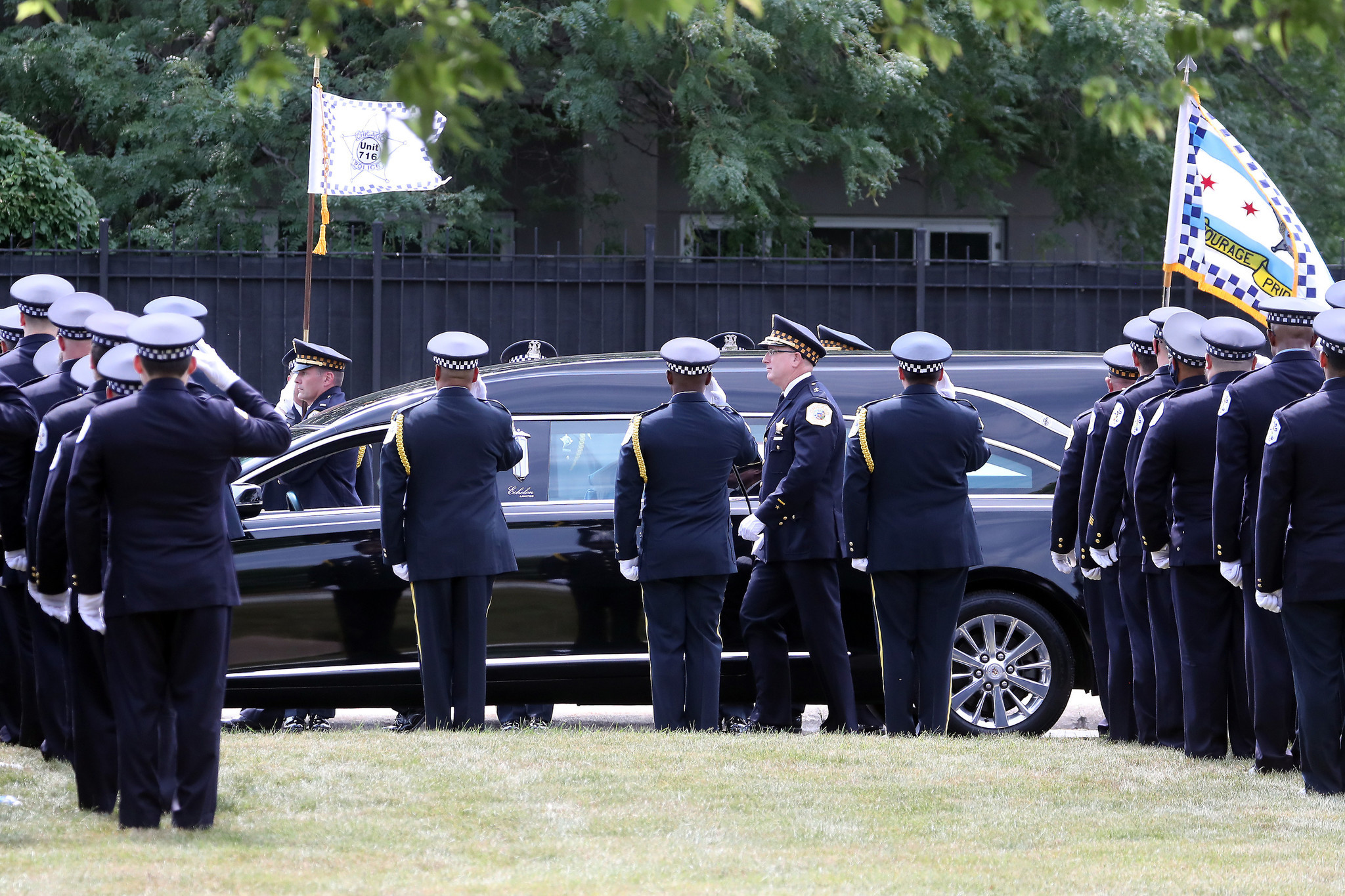 A hearse carrying the flag-draped casket bearing the remains of...