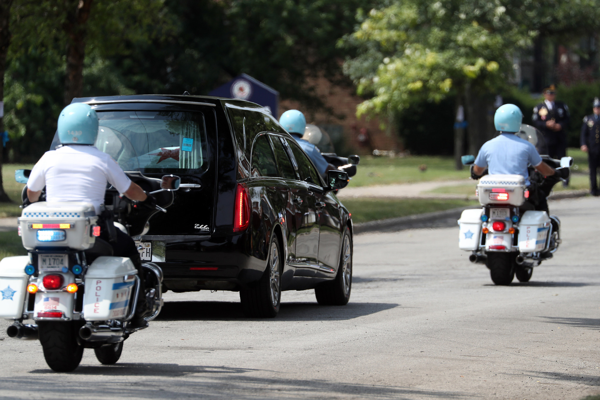 A hearse carrying the flag-draped casket bearing the remains of...