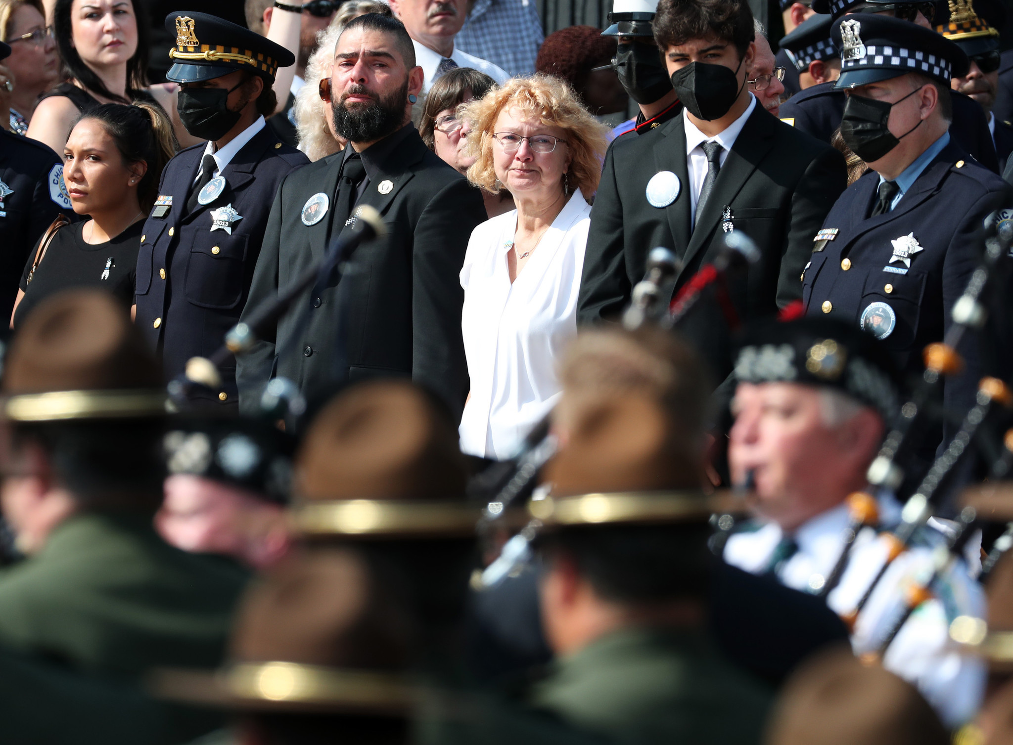 Elizabeth French, center right, and son Andrew, center left, watch...