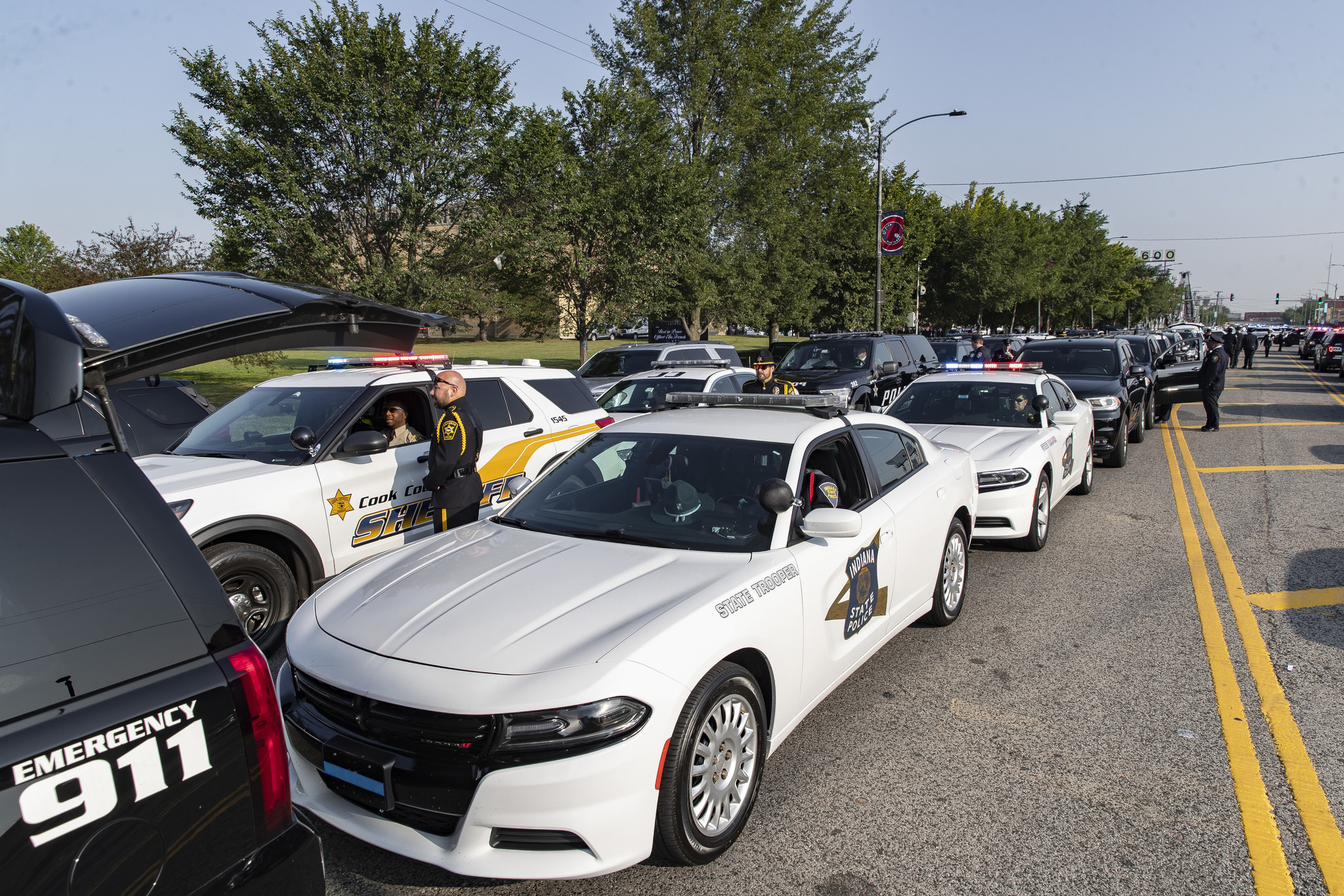 Area law enforcement agency vehicles line South Western Avenue before...
