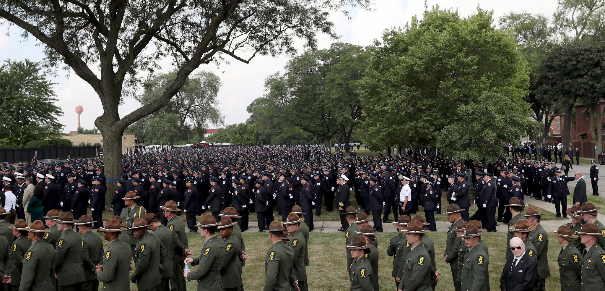 Police officers, firefighters and state troopers stand outside during the...