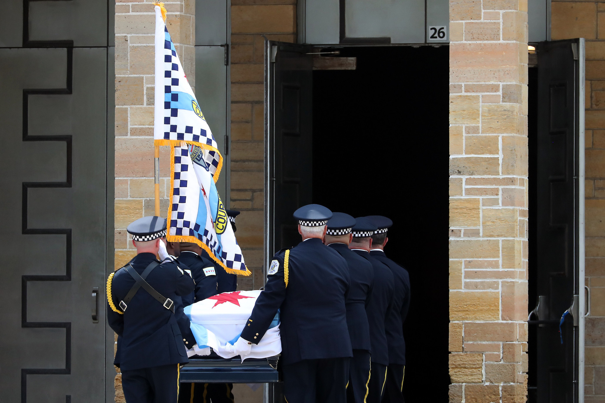 A flag-draped casket bearing the remains of slain Chicago police...