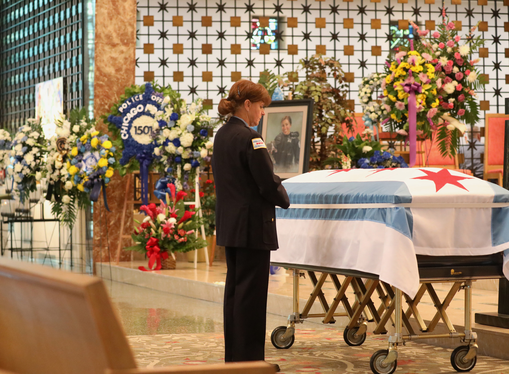 A mourner pauses at the casket of Chicago police Officer...