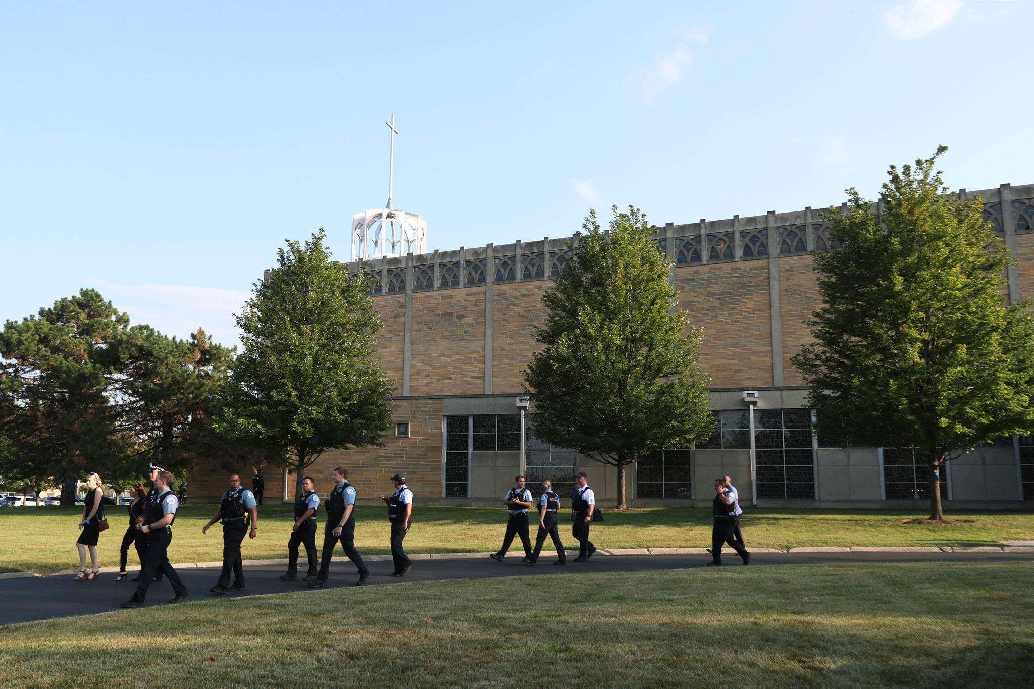 Police officers exit after attending the visitation for Ella French,...