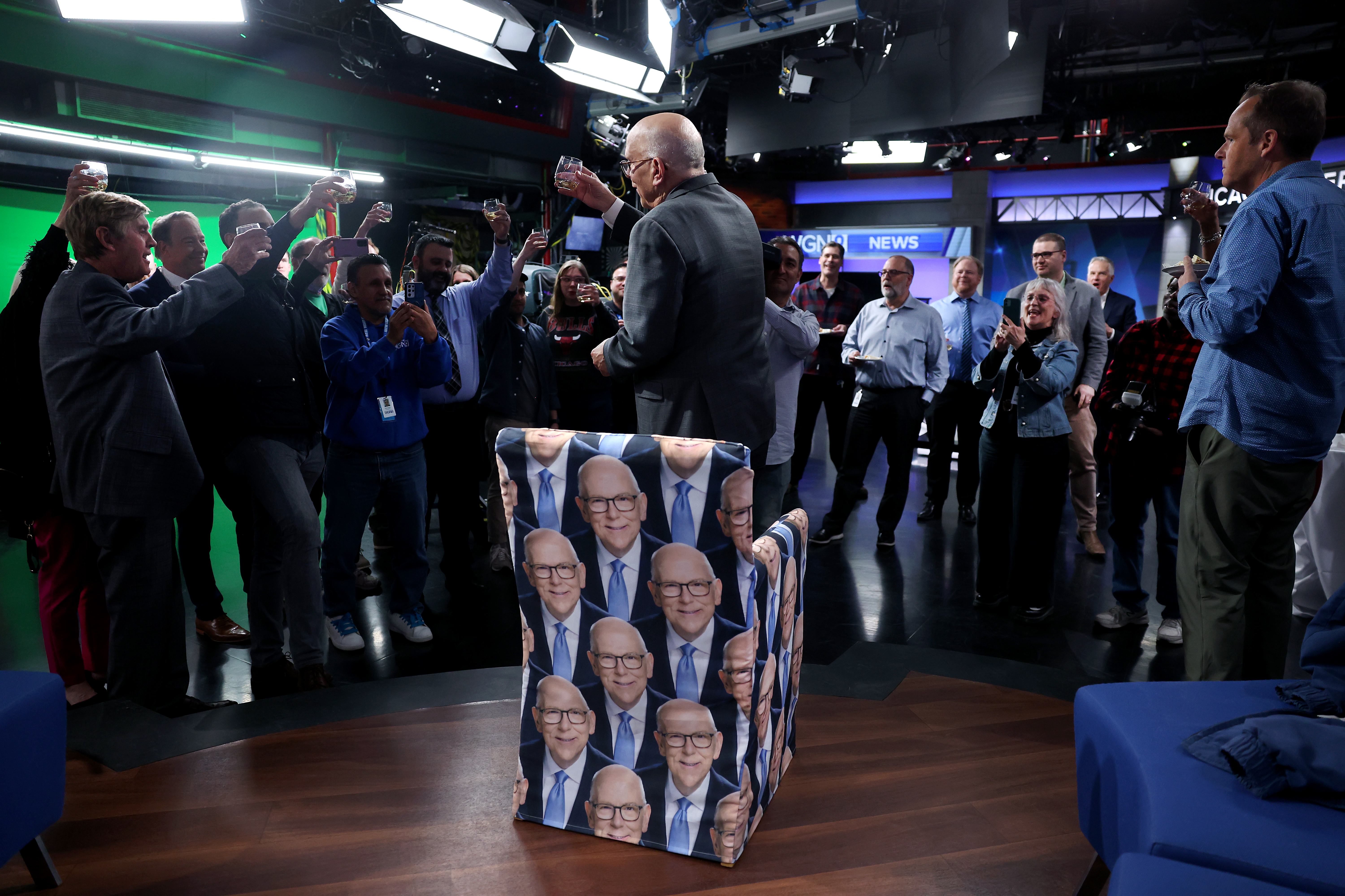 WGN-TV chief meteorologist Tom Skilling is toasted while standing in front of a chair featuring his likeness as family, friends, and current and former colleagues celebrate his career following Skilling's final broadcast on Feb. 28, 2024. (Chris Sweda/Chicago Tribune)