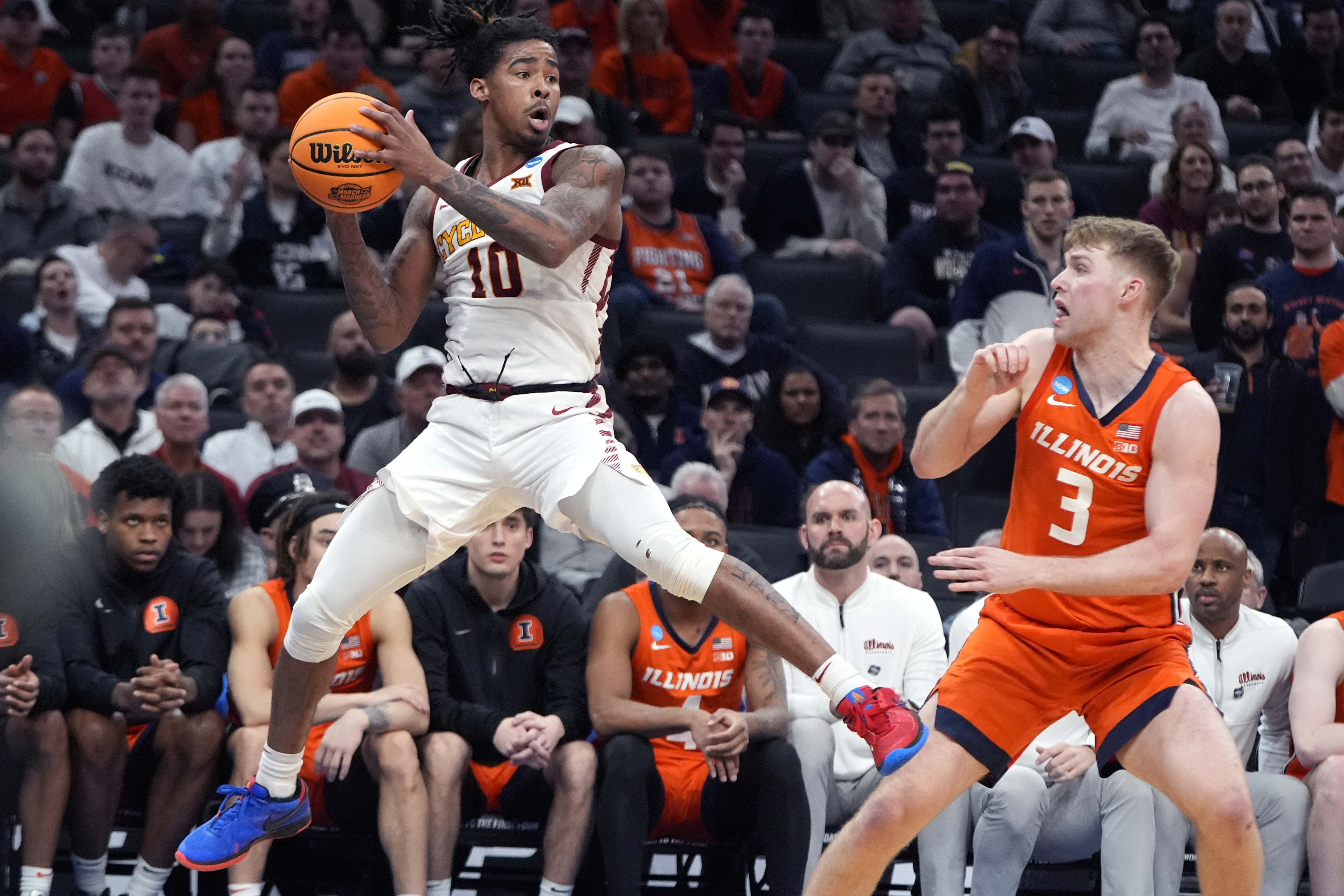 Iowa State guard Keshon Gilbert (10) looks to pass while covered by Illinois forward Marcus Domask (3) during the second half of the Sweet 16 college basketball game in the men's NCAA Tournament, Thursday, March 28, 2024, in Boston. (AP Photo/Michael Dwyer)
