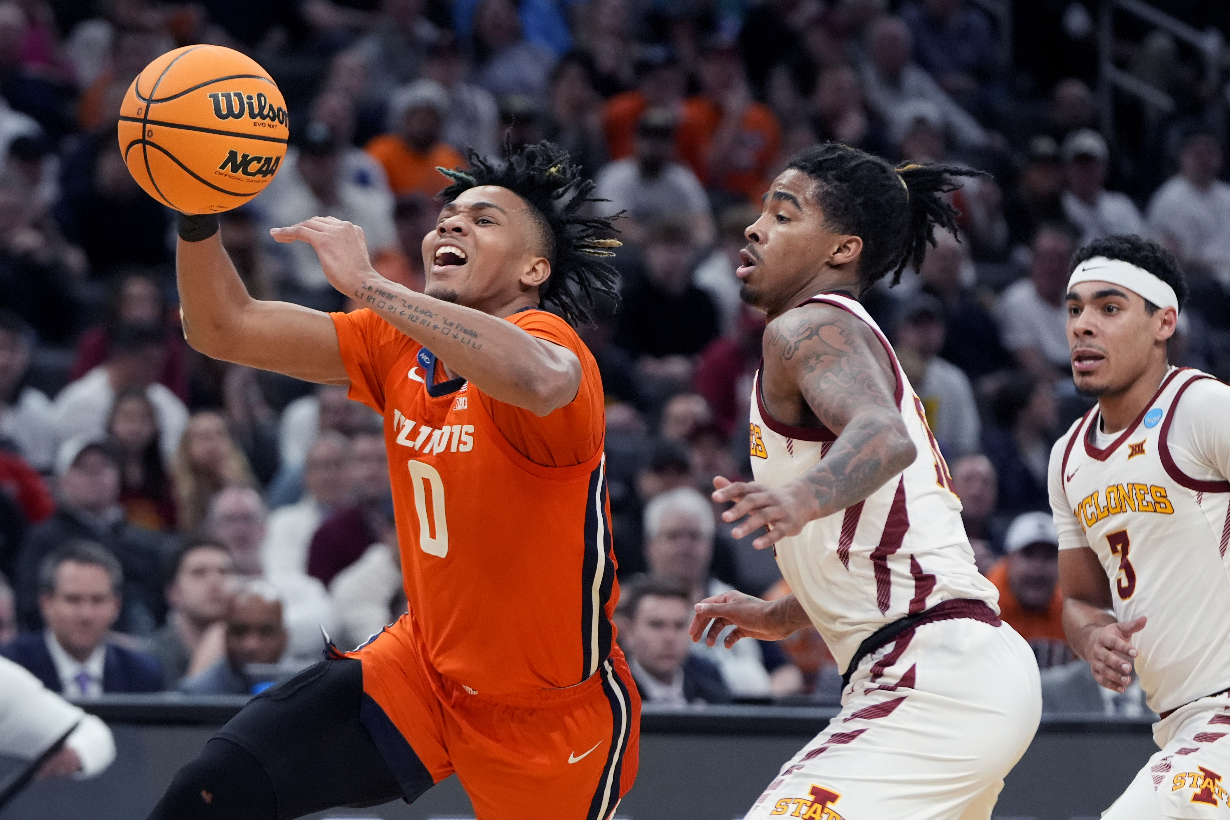 Illinois guard Terrence Shannon Jr. (0) drives to the basket past Iowa State guard Keshon Gilbert, center, during the second half of the Sweet 16 college basketball game in the men's NCAA Tournament, Thursday, March 28, 2024, in Boston. (AP Photo/Michael Dwyer)