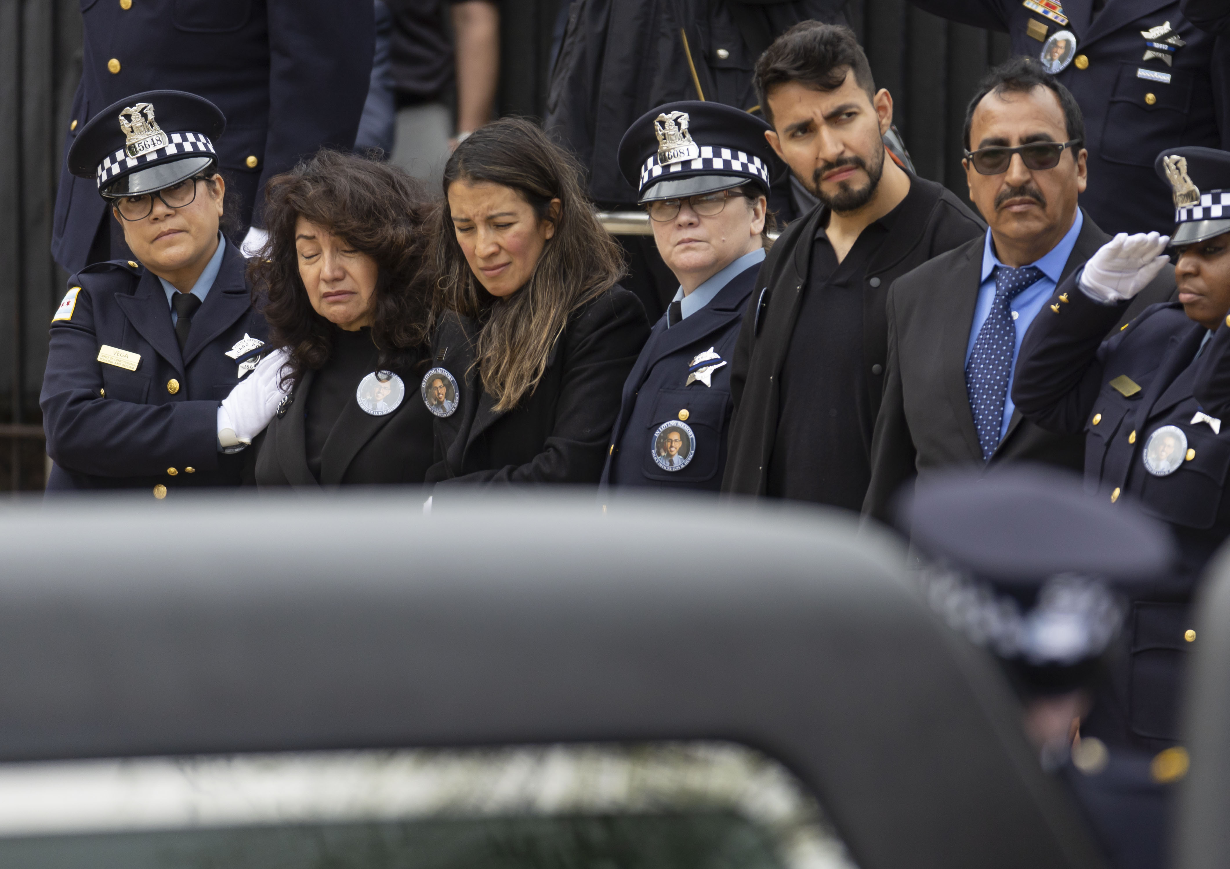 Edith Huesca, mother of slain Chicago police Officer Luis M. Huesca, and his sister, Lily O'Brien, watch as his casket arrives for his funeral, April 29, 2024, at St. Rita of Cascia Shrine Chapel. Huesca, a six-year veteran officer, was returning home last week after a shift in the CPD's Calumet District when he was fatally shot. (Brian Cassella/Chicago Tribune)