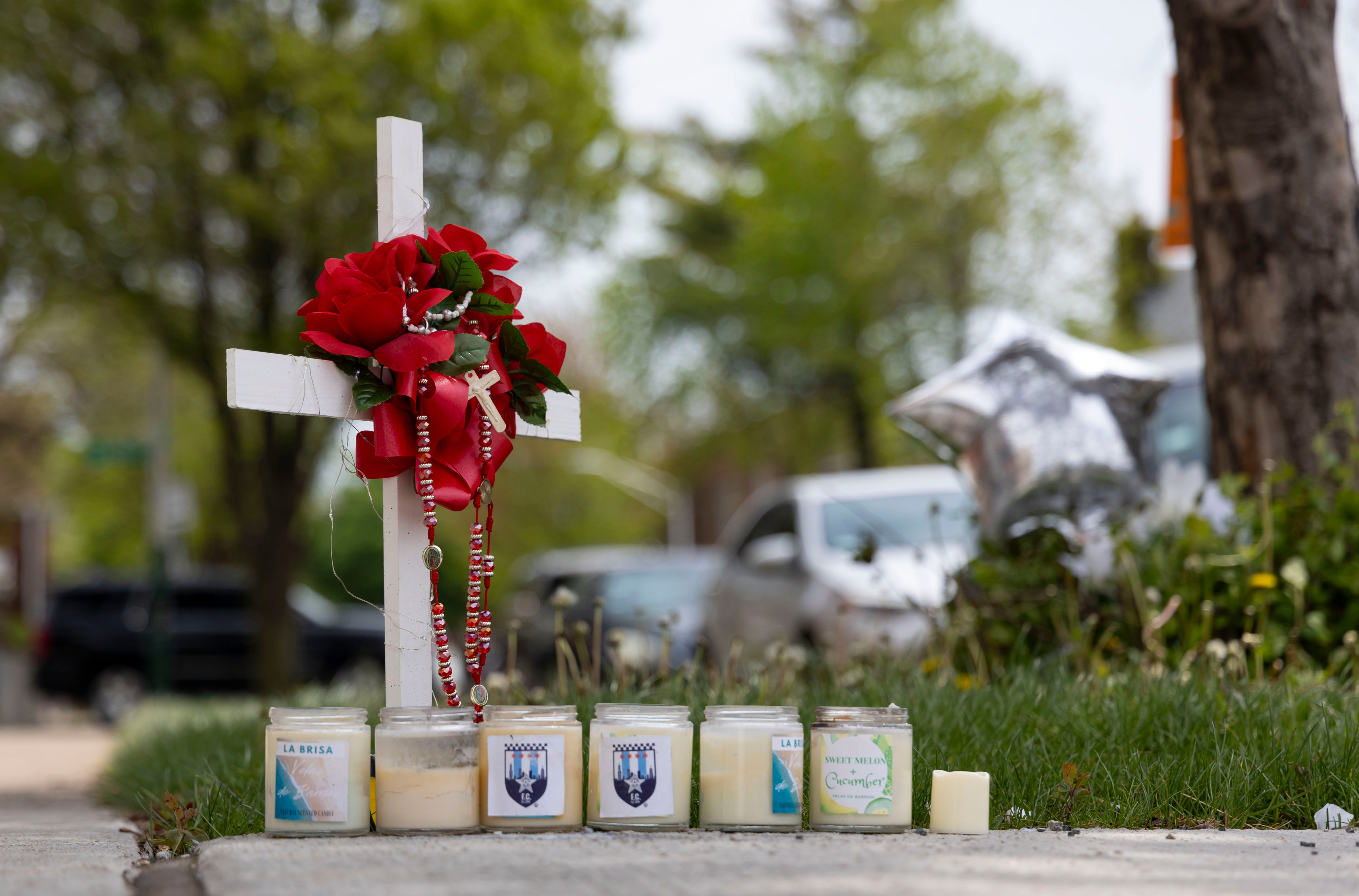 Candles and flowers are left, April 28, 2024, at a memorial in Gage Park where Chicago police Officer Luis M. Huesca was shot and killed last weekend. (Brian Cassella/Chicago Tribune)