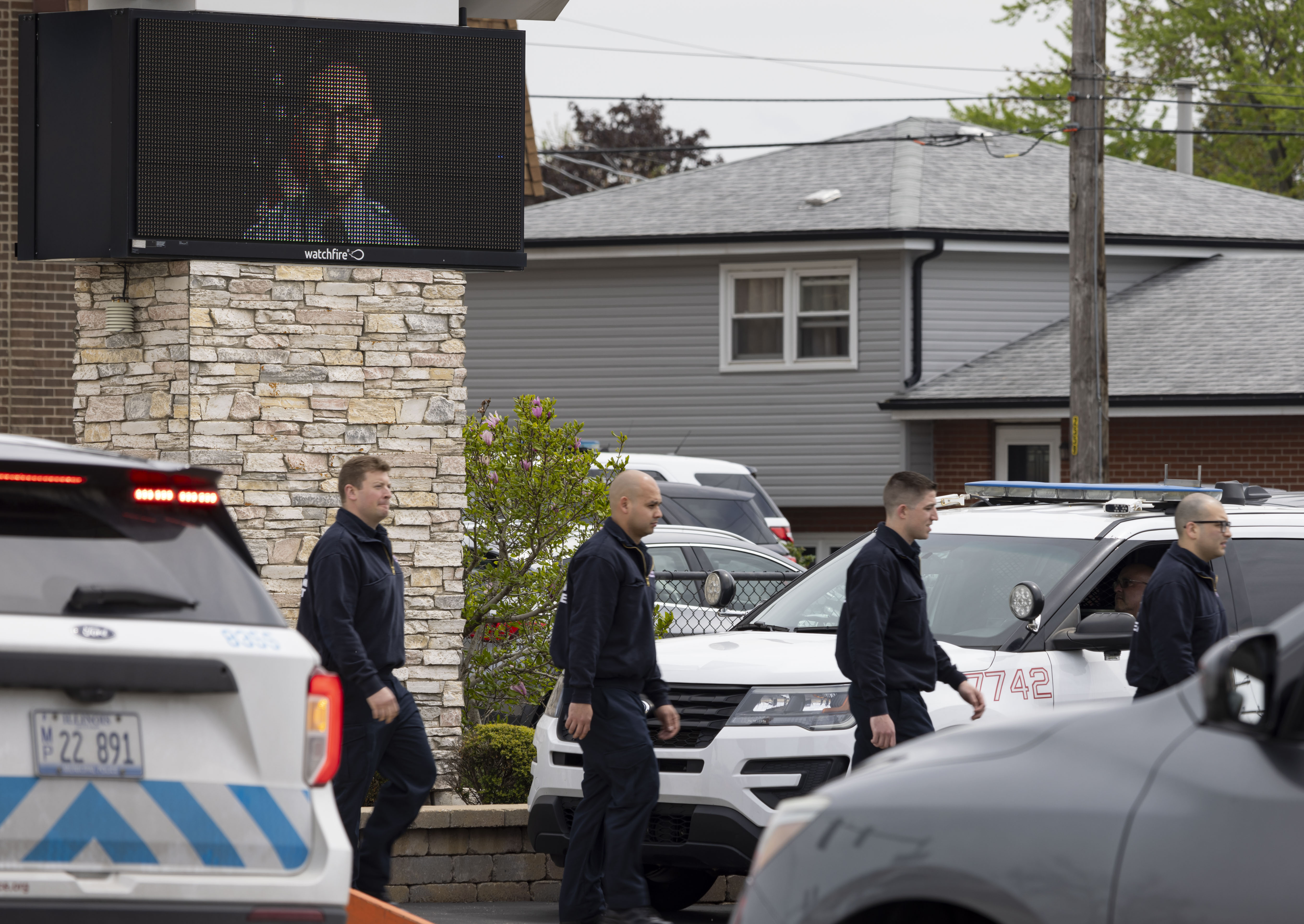 A picture of Chicago police Officer Luis M. Huesca is projected as people line up to enter his visitation, April 28, 2024, at Blake-Lamb Funeral Home in Oak Lawn. Huesca, a CPD officer for six years, was returning home last week after a shift in the Calumet District when he was fatally shot. (Brian Cassella/Chicago Tribune)