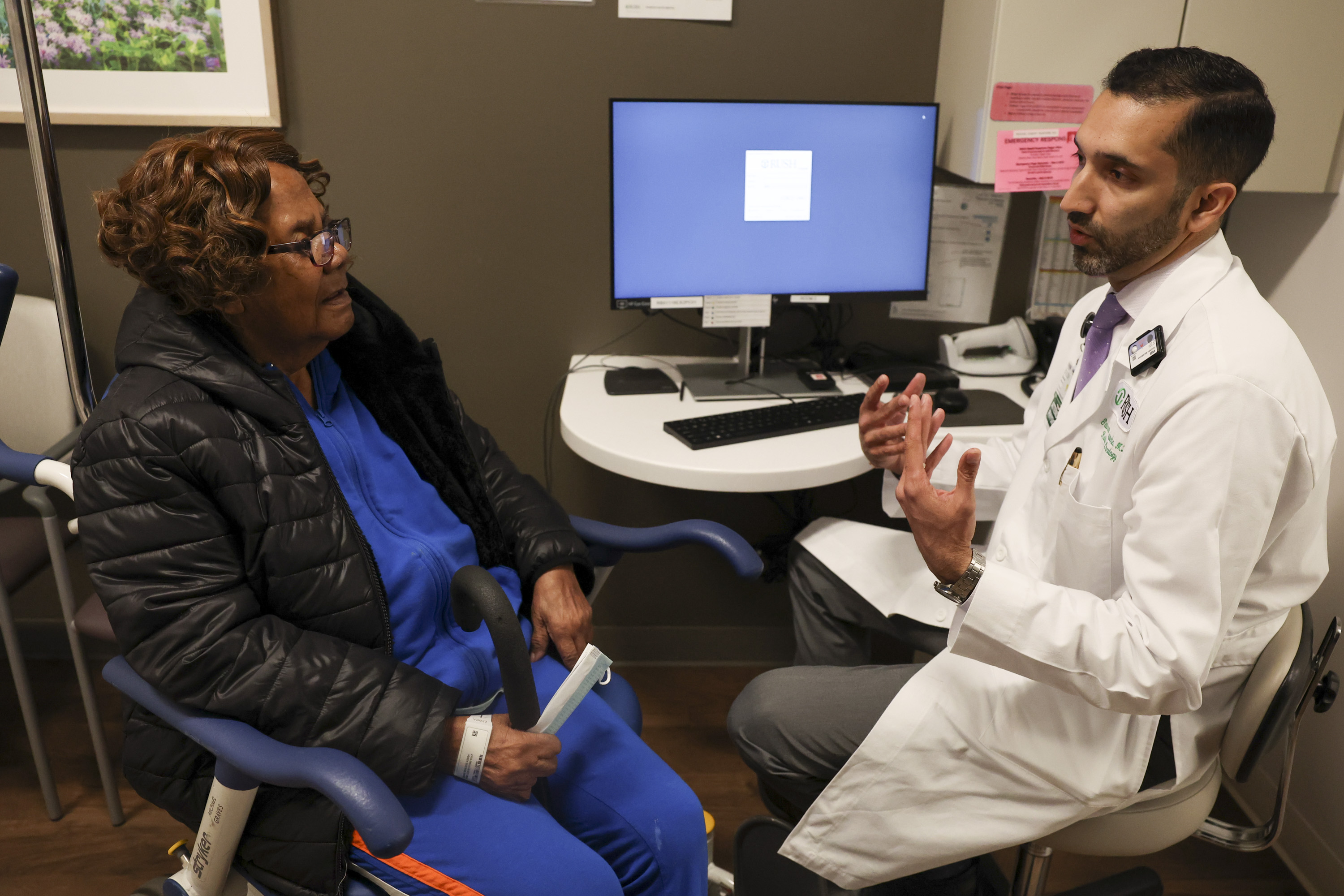 Dr. Gaurav Marwaha, interim chairperson in the Department of Radiation Oncology, checks in with cancer patient Louise Yates, left, at the Rush Rubschlager Building on April 25, 2024. (Eileen T. Meslar/Chicago Tribune)