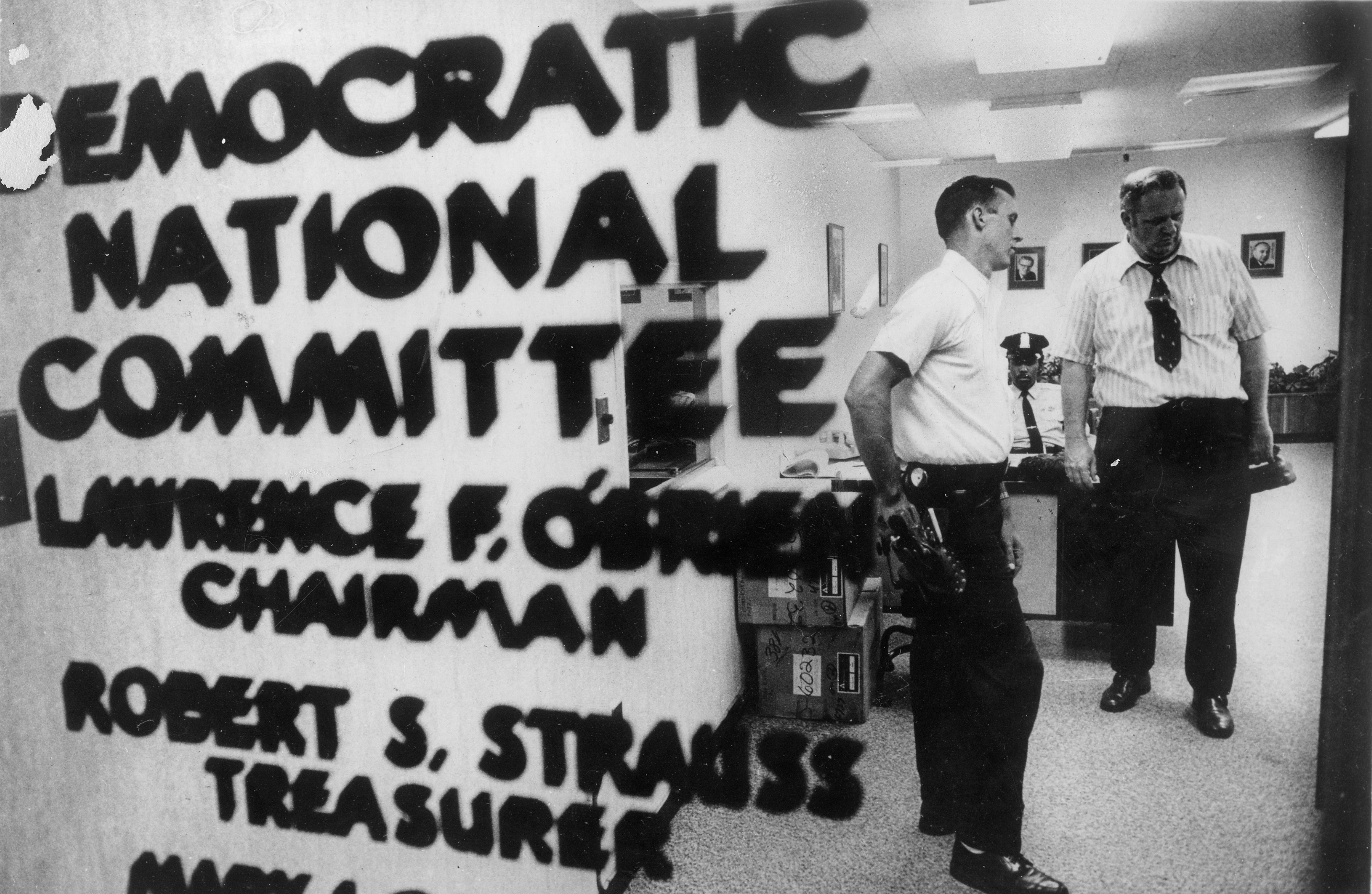 Police and telephone men check out the Democratic National Committee headquarters in Washington in June 1972 after five men were arrested during a break-in attempt. Authorities called it an elaborate plot to bug the office and said the men had photographic equipment and electronic listening devices. (Ken Feil/Washington Post)