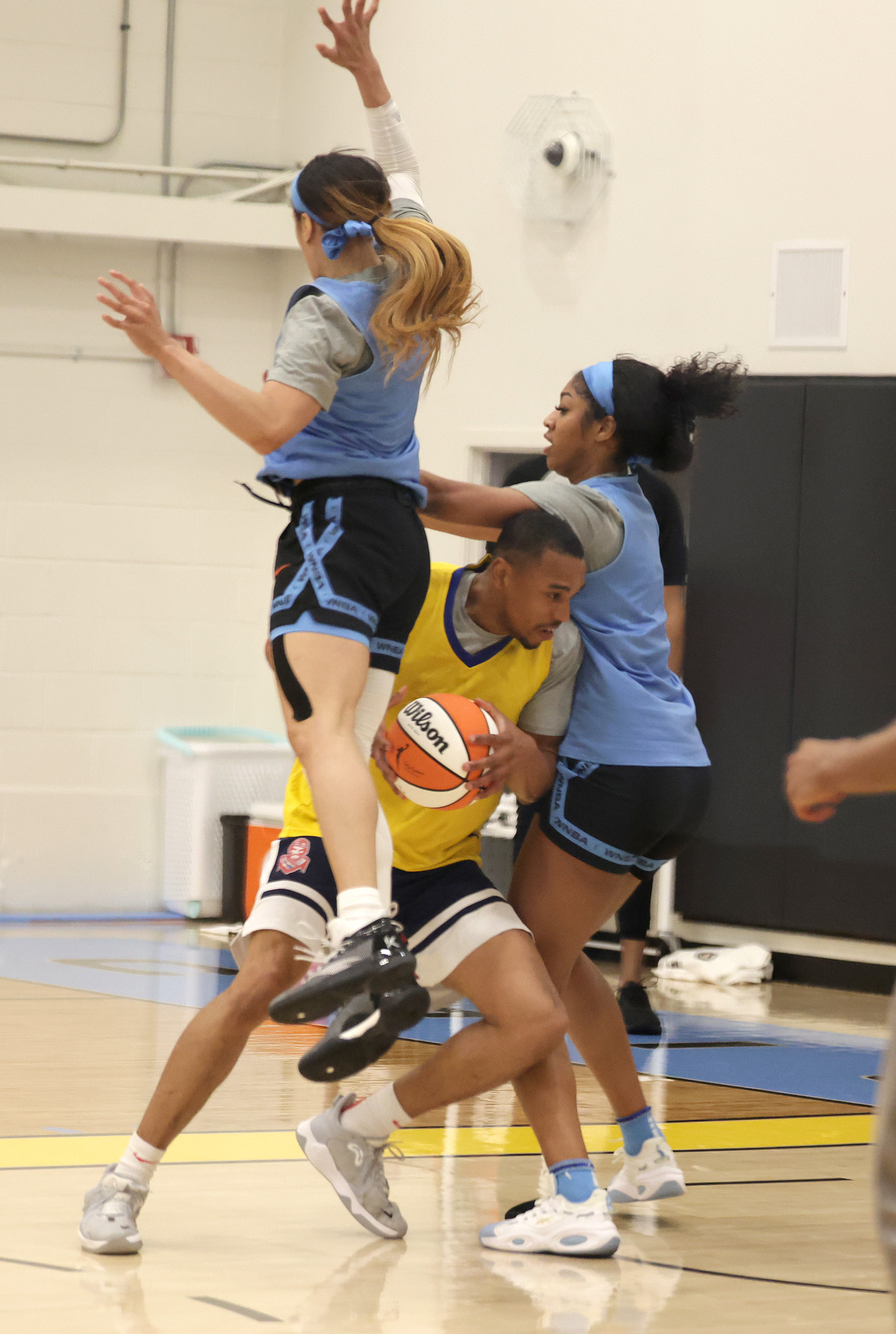Rookie Angel Reese, right, and Chennedy Carter, left, double team a practice player during Chicago Sky training camp at the Sachs Recreation Center on May 1, 2024, in Deerfield. (Stacey Wescott/Chicago Tribune)
