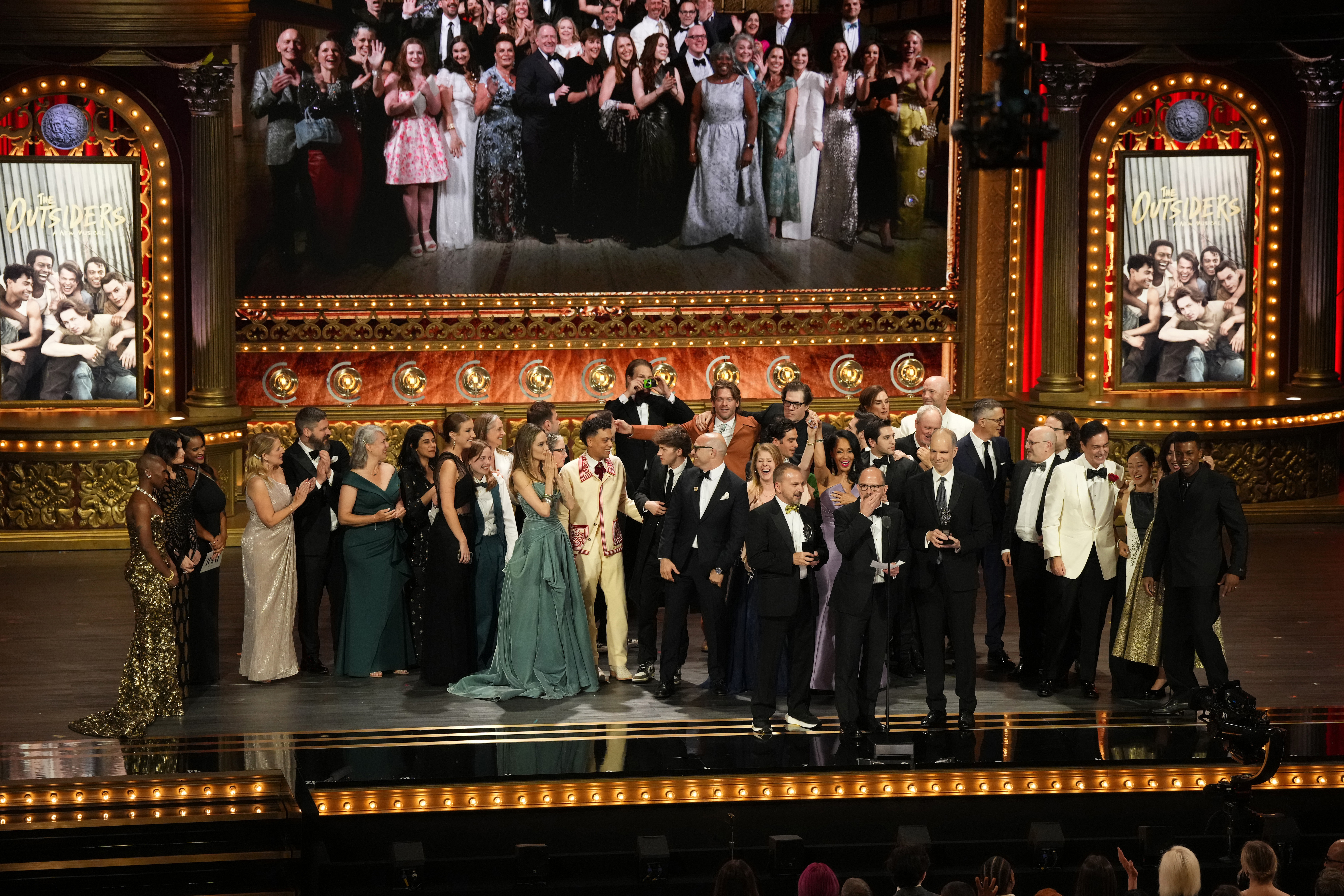 Michael Rego, Matthew Rego, Hank Unger and members of the company of "The Outsiders" accept the award for best musical during the 77th Tony Awards on June 16, 2024, in New York. (Charles Sykes/Invision/AP)