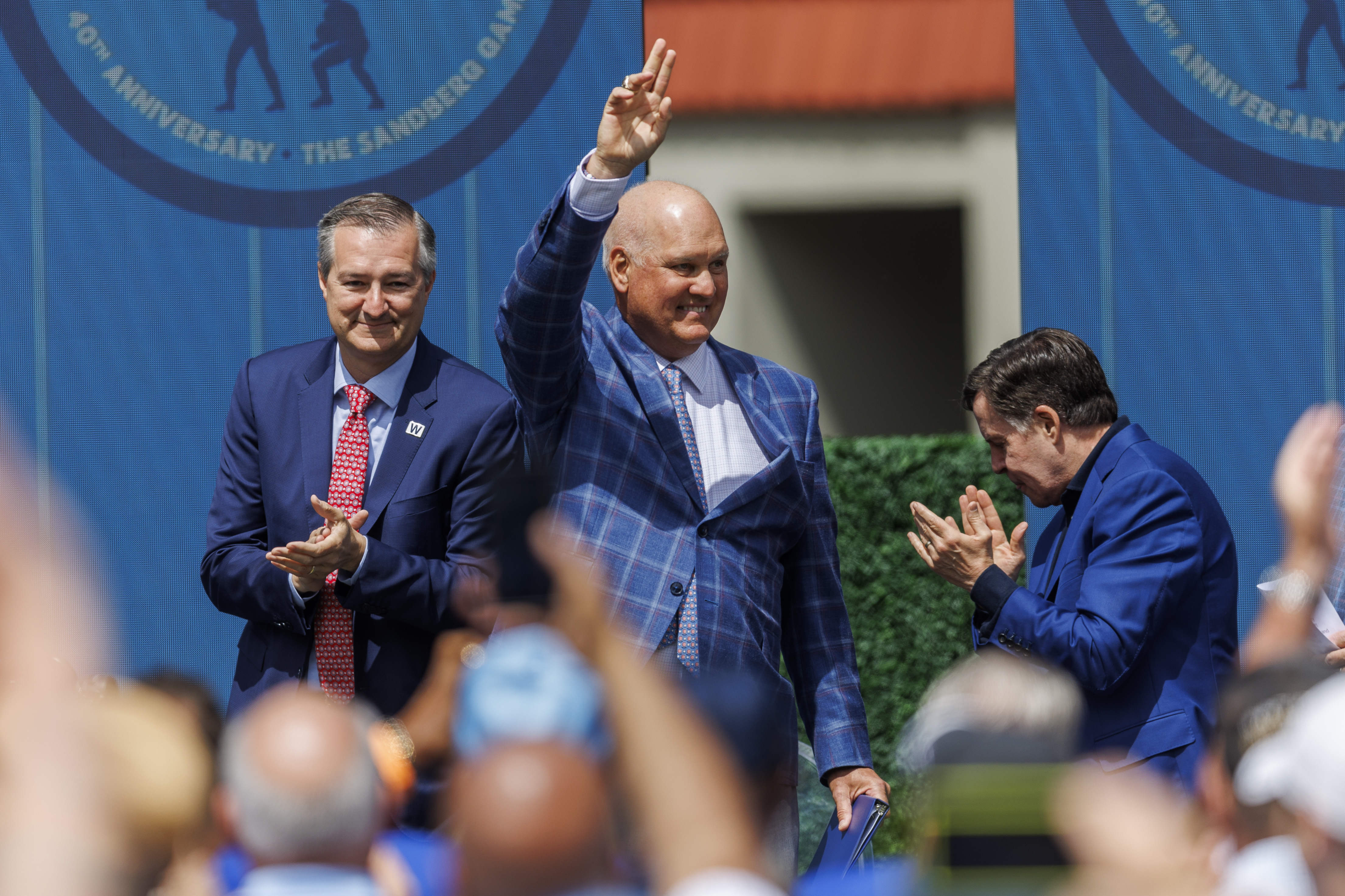 Former Cubs player Ryne Sandberg, center, stands next to Cubs Chairman Tom Ricketts, left, and sports broadcaster Bob Costas, right, while attending a dedication ceremony for his statue outside Wrigley Field Sunday June 23, 2024 in Chicago. (Armando L. Sanchez/Chicago Tribune)