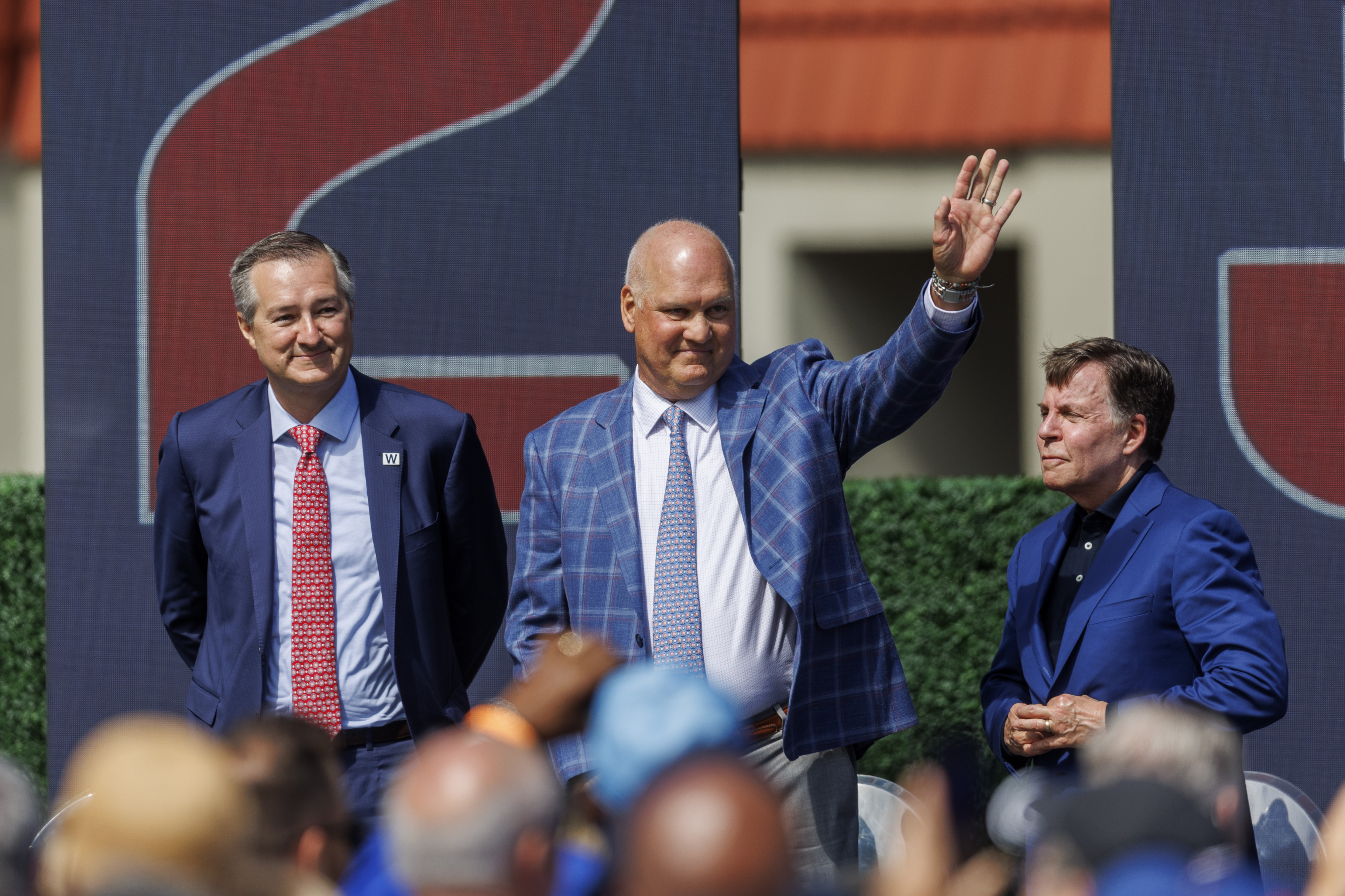 Former Cubs player Ryne Sandberg, center, stands next to Cubs Chairman Tom Ricketts, left, and sports broadcaster Bob Costas, right, while attending a dedication ceremony for his statue outside Wrigley Field Sunday June 23, 2024 in Chicago. (Armando L. Sanchez/Chicago Tribune)