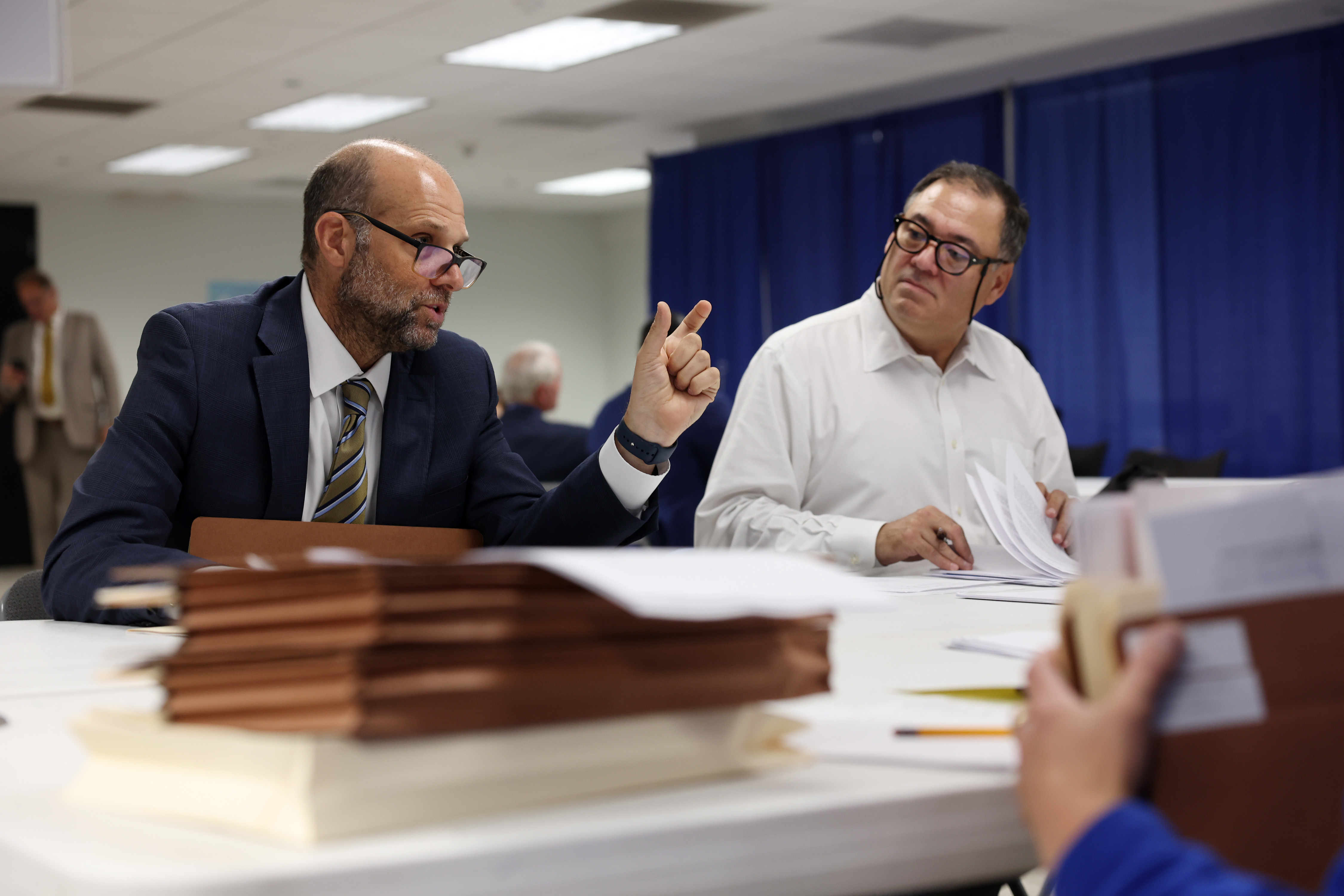 Attorneys Steven Fine, left, and Scott Erdman discuss scheduling for upcoming hearings on behalf of their clients during an initial objections hearing for school board candidates at a Board of Elections meeting room at 69 W. Washington St. on July 9, 2024, in Chicago. (John J. Kim/Chicago Tribune)