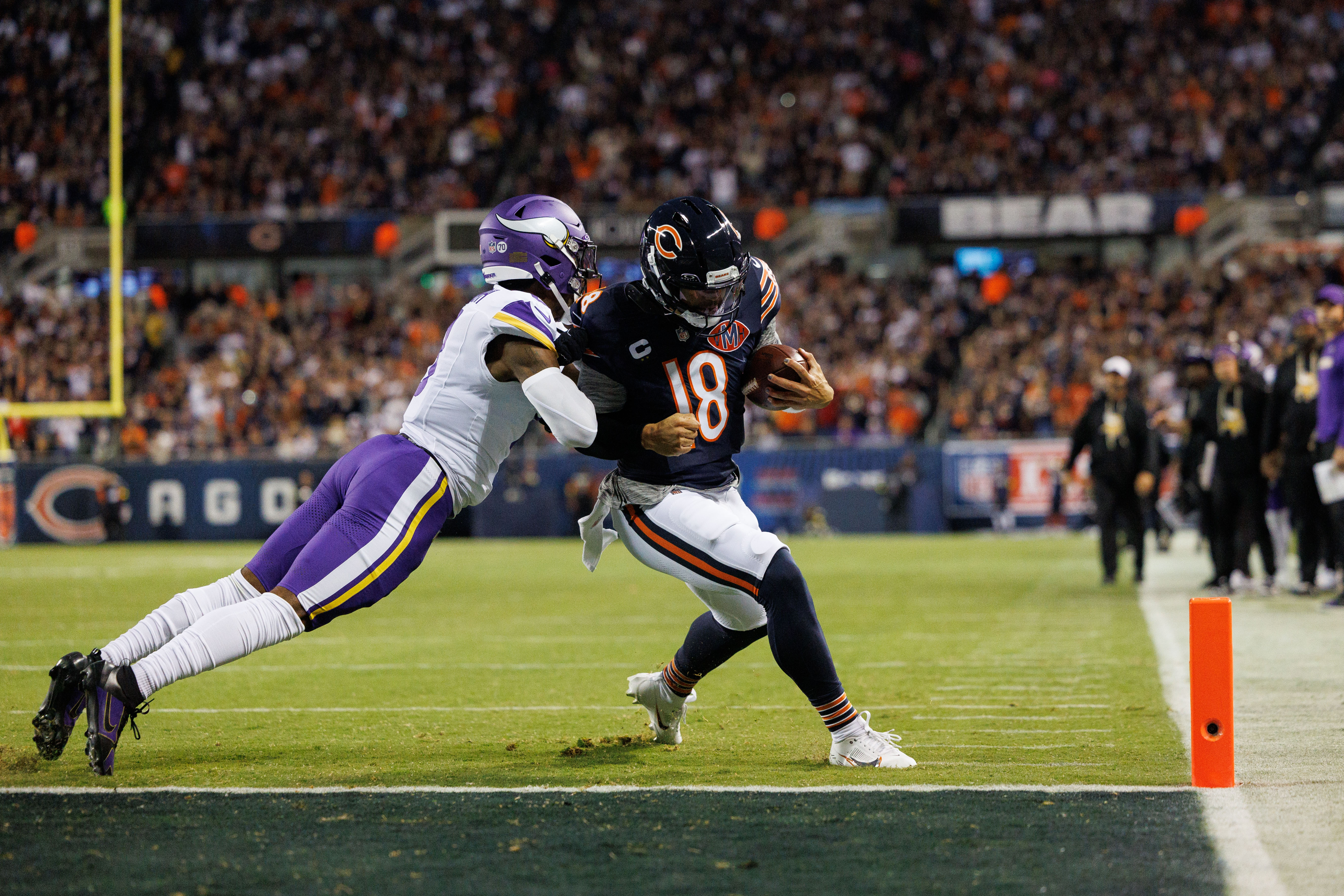 Chicago Bears quarterback Caleb Williams (18) scores a touchdown past Minnesota Vikings cornerback Jeff Okudah (8) during the first quarter at Soldier Field Monday Sept. 8, 2025, in Chicago. (Armando L. Sanchez/Chicago Tribune)