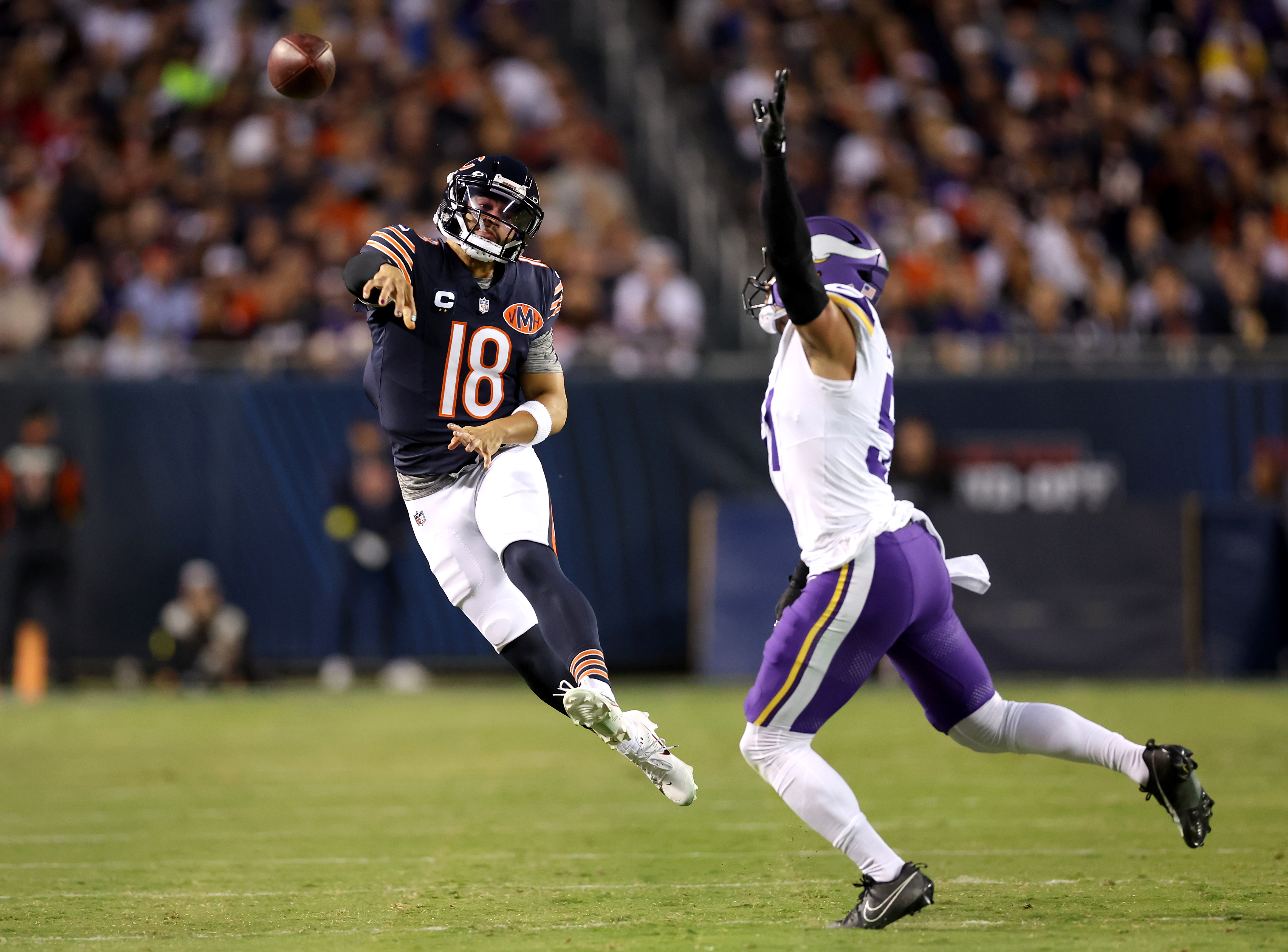 Chicago Bears quarterback Caleb Williams (18) throws a pass for a first down to wide receiver Rome Odunze as Minnesota Vikings linebacker Blake Cashman (51) defends on the play in the first quarter of a game at Soldier Field in Chicago on Sept. 8, 2025. (Chris Sweda/Chicago Tribune)